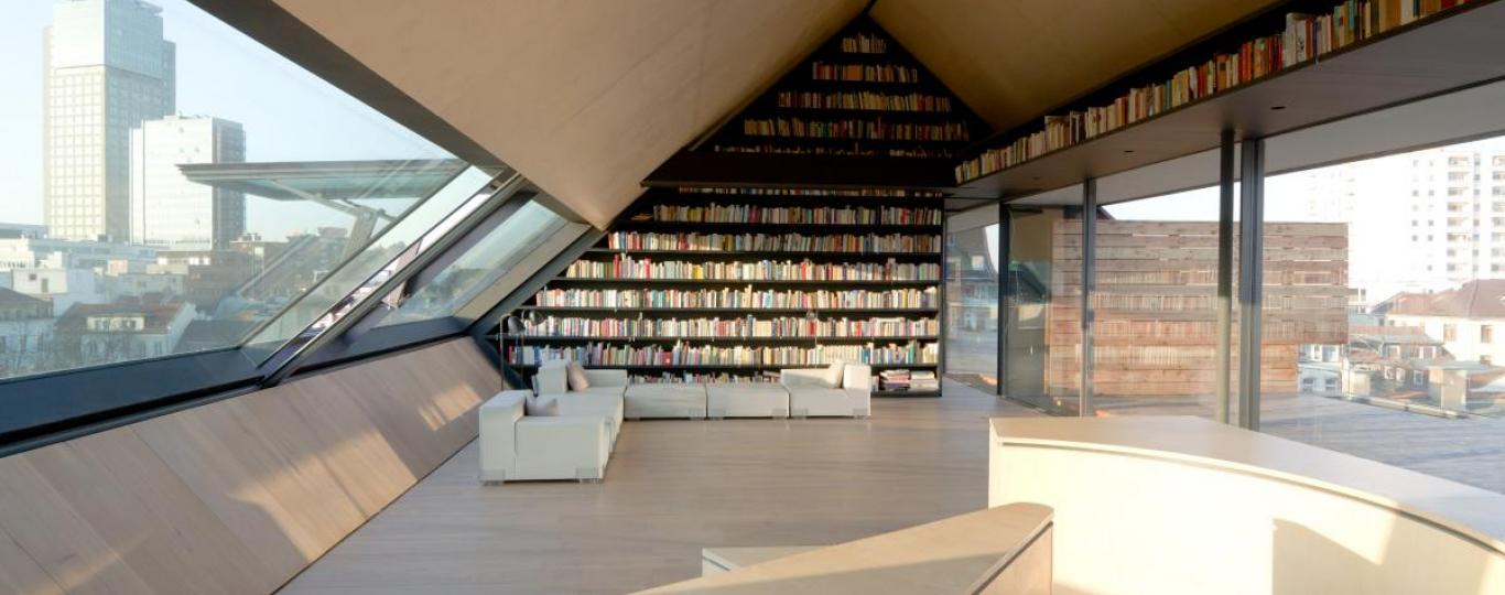 light-flooded attic with city view and book shelves